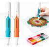 A hand holds an automatic diamond painting bead dispenser and precision press tool with various colored beads displayed on a 