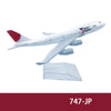 A white diecast model of a Japan Airlines airplane with red markings and tail, viewed from the side.
