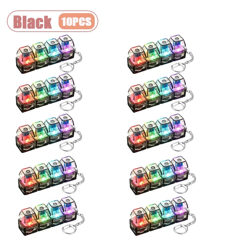 A set of black LED keyboard keycap fidget keychains for stress relief, showing various colors and designs.