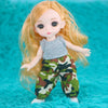 A blonde Articulated BJD princess doll with long hair wearing a gray top and camouflage pants.