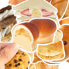 A hand holds a sliced pastry, showing the interior and exterior texture of a baked good.