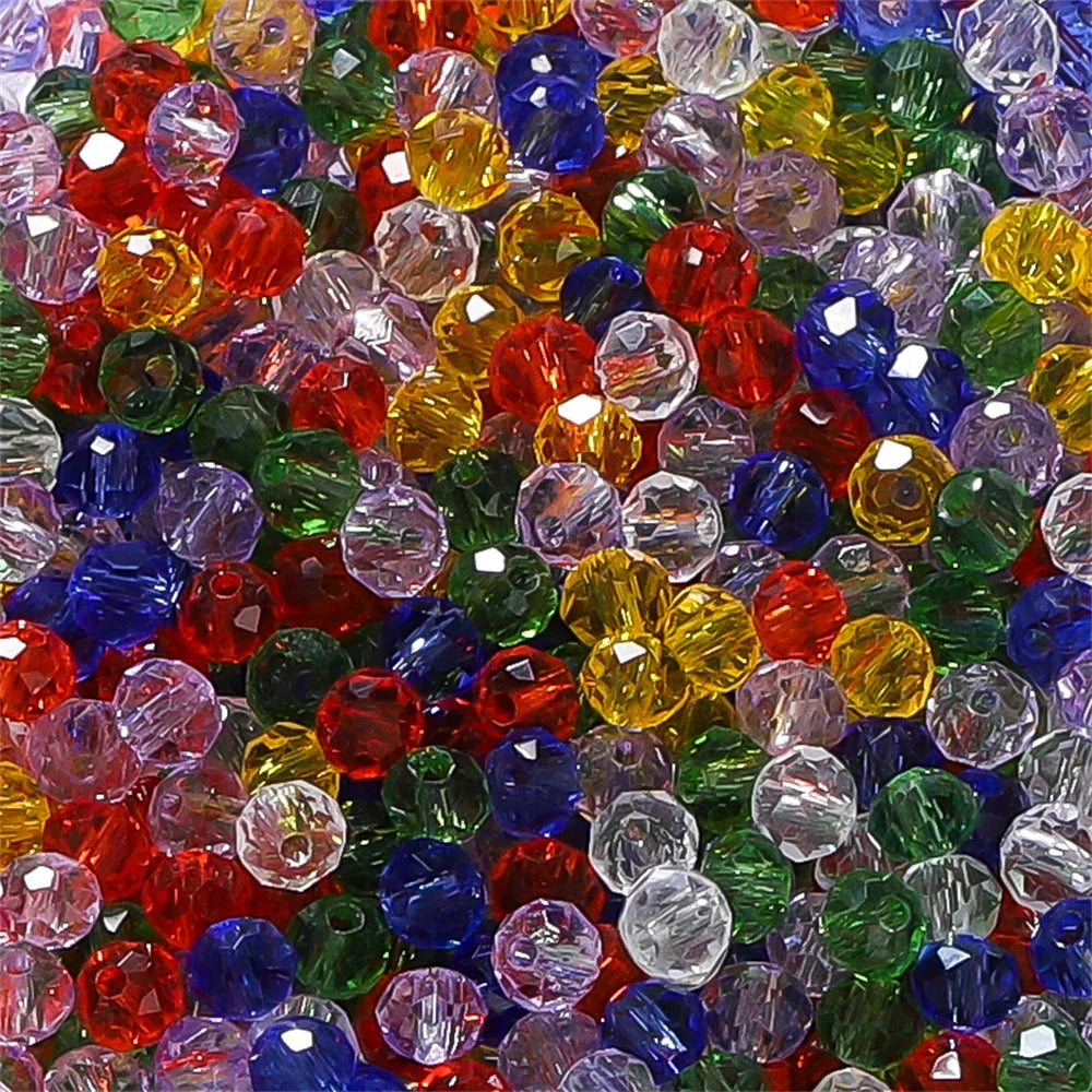 A close-up view of a mixed assortment of faceted rondelle glass beads in various colors including red, blue, green, yellow, a
