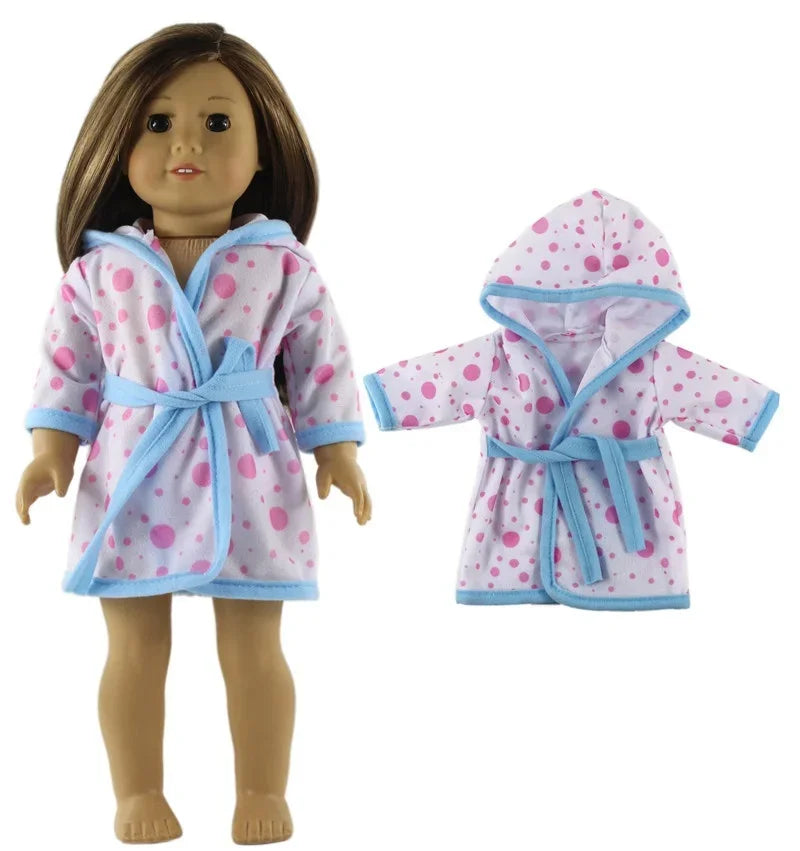 A doll wearing a pink and blue polka dot hooded outfit set.