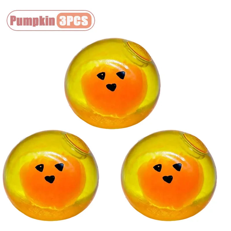 Three yellow pumpkin head squishy stress relief toys