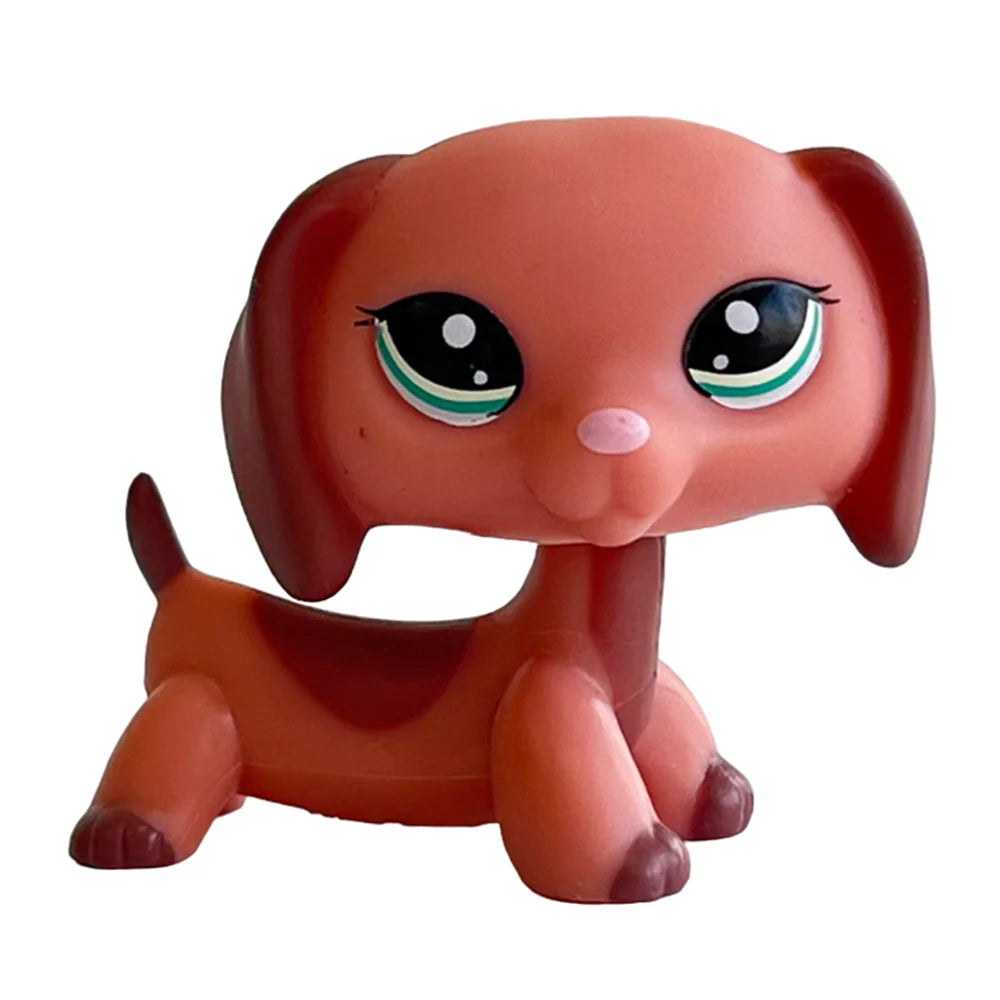 A small, round Bobblehead toy of a deer with reddish-brown fur and green glowing eyes.