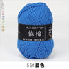 A skein of bright blue milk cotton yarn labeled 55# in a ball for knitting and crochet.