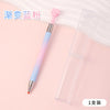 A gradient rotating dotting pen with a pink handle and clear body is shown next to its packaging.