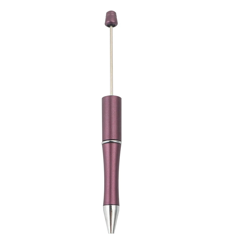 A silver and purple beadable ballpoint pen with a black ink tip.