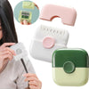 A hand holds a white baby hair cutting comb and a pink hair clipper, demonstrating the dual-edge tool.