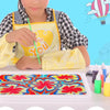 A child wearing an apron is painting a colorful floral design on a white tray with water marbling paint.