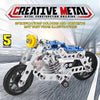 A silver and blue metal construction kit of a motorcycle model shown in a studio setting.
