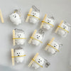 Clear plastic bags containing white squishy toys shaped like cute bears with wooden sticks.