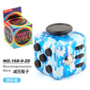 A blue and white fidget cube is shown next to its packaging, featuring silent and clicking buttons.