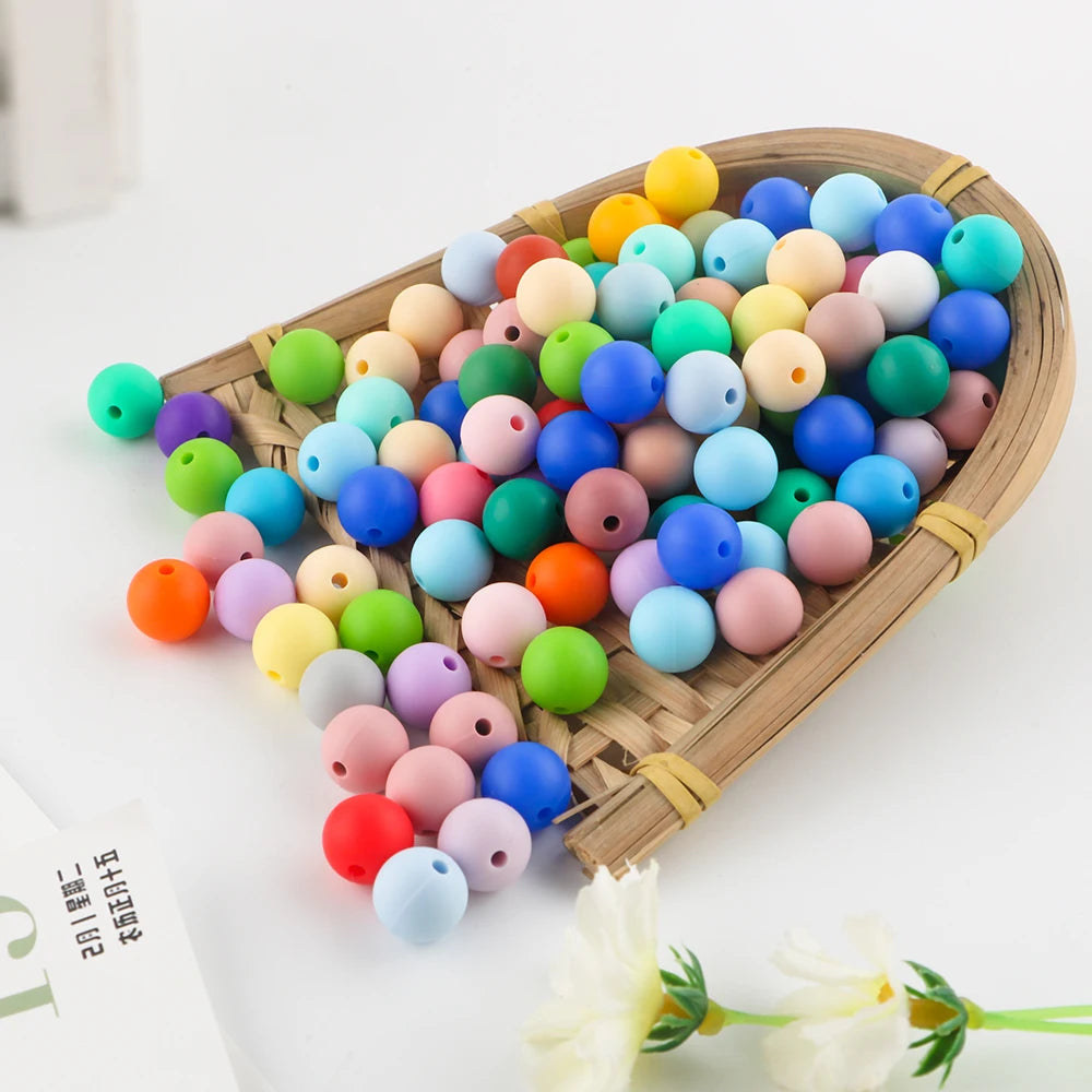 A wooden tray filled with colorful silicone round beads for jewelry making and DIY crafts