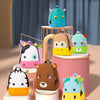 A collection of colorful 3D animal kids backpacks, including a blue dinosaur, yellow bear, and green panda, displayed on a wo