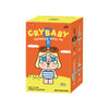 A yellow box for a Crybaby Vacation Mode On vinyl plush pendant blind box featuring a character with large eyes and hair.