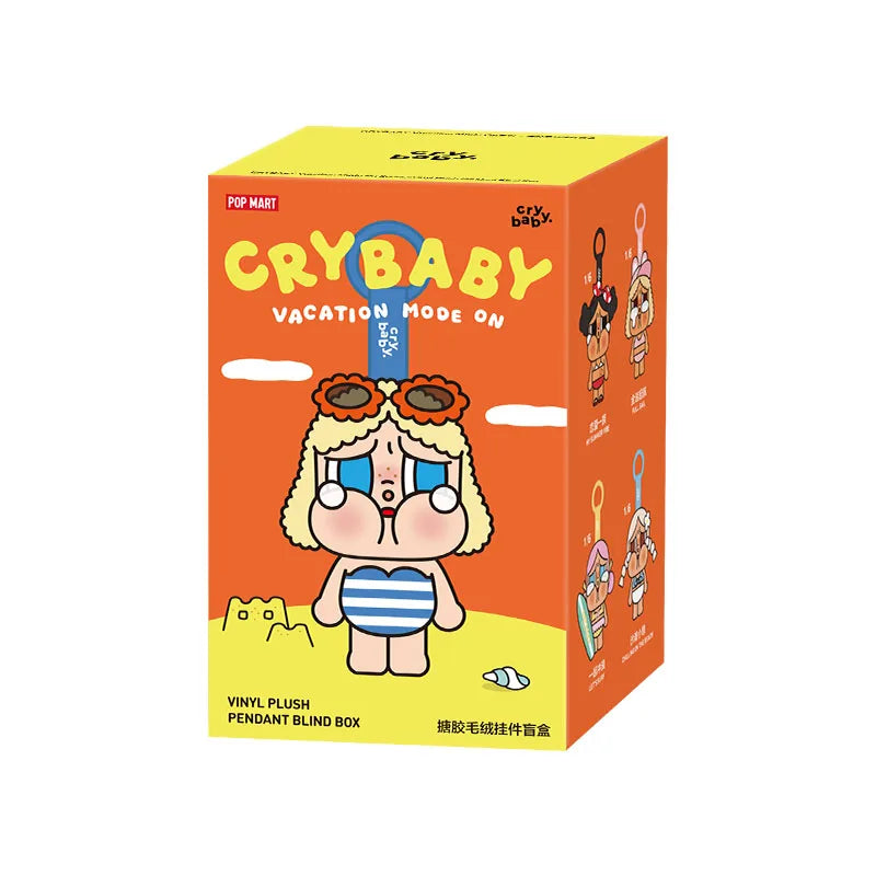 A yellow box for a Crybaby Vacation Mode On vinyl plush pendant blind box featuring a character with large eyes and hair.