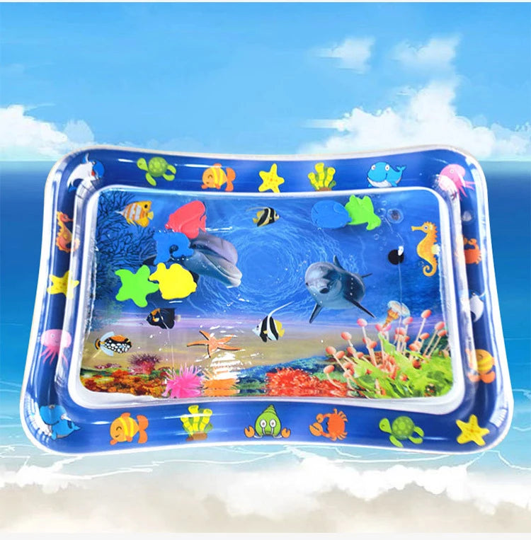A blue inflatable baby water play mat filled with colorful aquatic toys and marine life set against a bright blue sky backgro