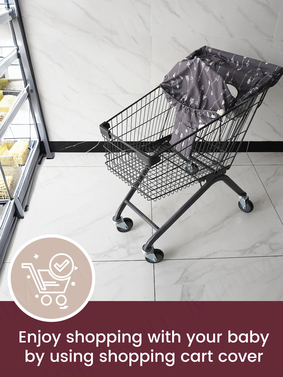 A black wire shopping cart with a protective seat cover is shown on a tiled floor.