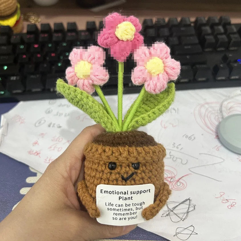 Handmade crochet sunflower pot doll with green leaves and a smiling face
