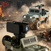 A model off-road vehicle, the Mini Alloy Simulated Off Road Vehicle, is shown driving through dusty terrain.