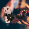 A hand is holding a metal guitar wall mount hanger with a padded yoke, demonstrating the product.