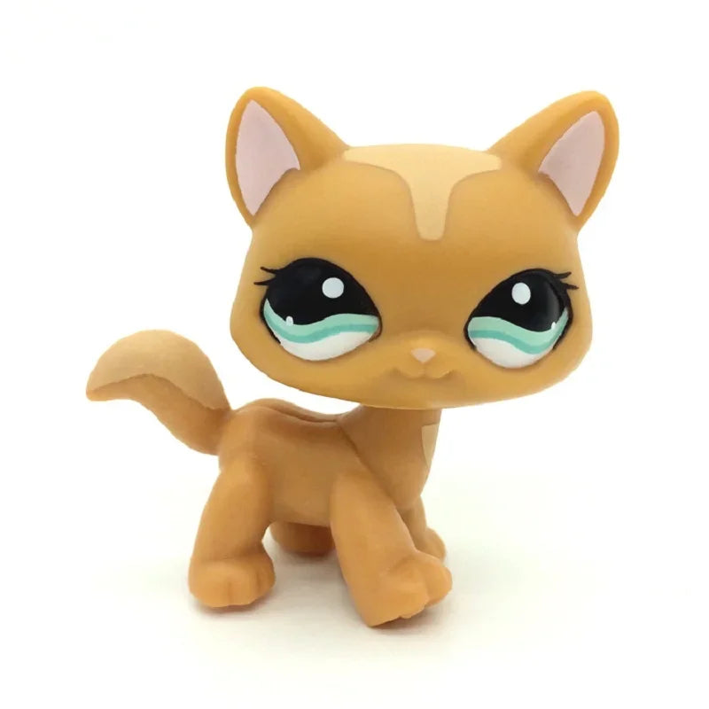 A small, tan and cream-colored Littlest Pet Shop style standing dog figure with large eyes.