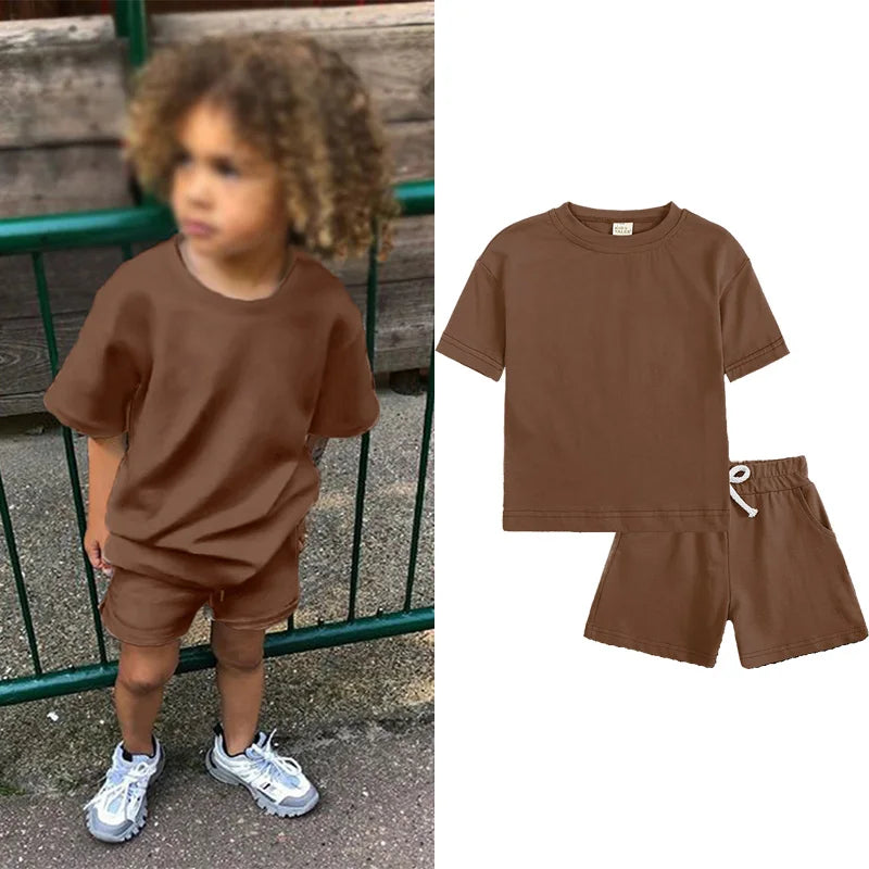 A brown kids summer tracksuit set featuring a short sleeve top and matching shorts.