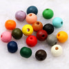 A collection of colorful natural wooden beads in various shades including orange, green, pink, and black.