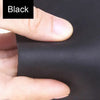 A hand is pressing a piece of black leather material, likely premium Crazy Horse leather, for crafting or leatherwork.
