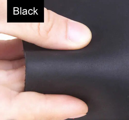A hand is pressing a piece of black leather material, likely premium Crazy Horse leather, for crafting or leatherwork.