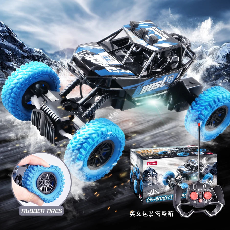 A black and blue off-road remote control car with large blue tires is shown alongside replacement rubber tires and a controll
