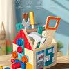 A wooden multi-functional tool basket featuring various tools like a hammer and screwdriver inside a house structure.