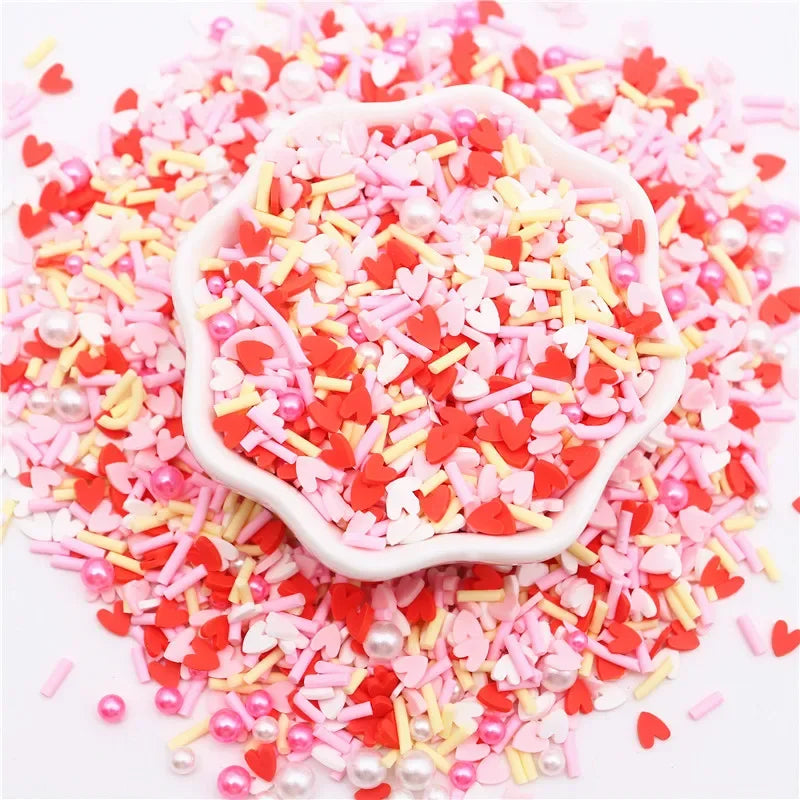A pile of pink and red polymer clay sprinkles mix used for slime decor and DIY craft accents.