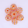 A cluster of ten small, spherical resin beads in mixed orange and clear tones for jewelry making.