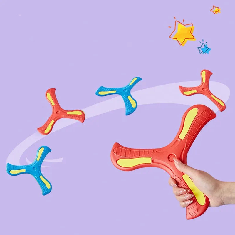 A hand holds an orange soft foam boomerang flying disc and a blue one against a light purple background.
