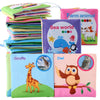 A collection of soft cloth books featuring various animals like a giraffe, owl, and sea creatures.