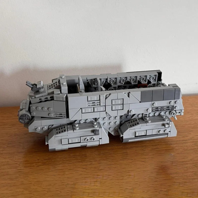 A gray LEGO model of an Imperial Troop Transport vehicle built from 697 building blocks.