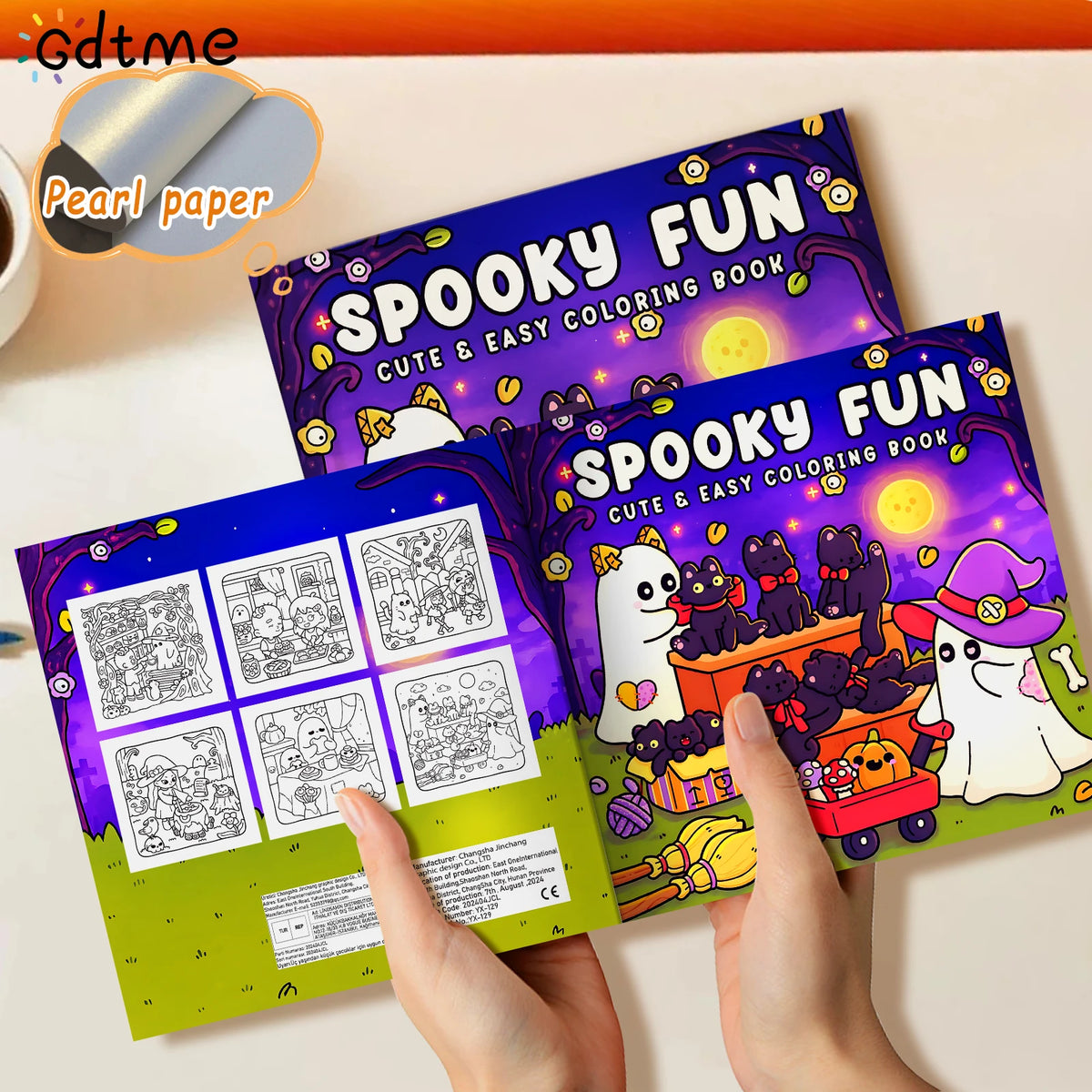 Hands hold a colorful Spooky Fun Halloween coloring book with detailed illustrations.