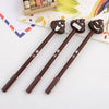 A pack of three brown novelty cartoon poop-shaped gel pens with smiling faces on a white background.