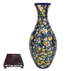 Blue and white porcelain flower vase with a textured base and a matching puzzle piece.