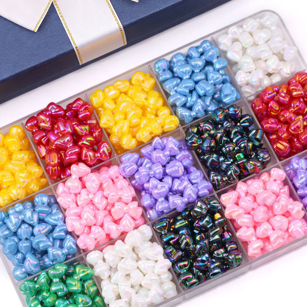 Assortment of colorful acrylic bow beads in various shades including blue, yellow, pink, purple, and green.