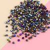 A pile of dark purple and bronze electroplated crystal glass beads for jewelry making