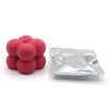 A pile of pink candle dye chips for soy wax, beeswax, and paraffin wax.