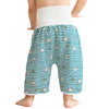 A baby wearing white absorbent diaper pants with a patterned skirt for potty training.