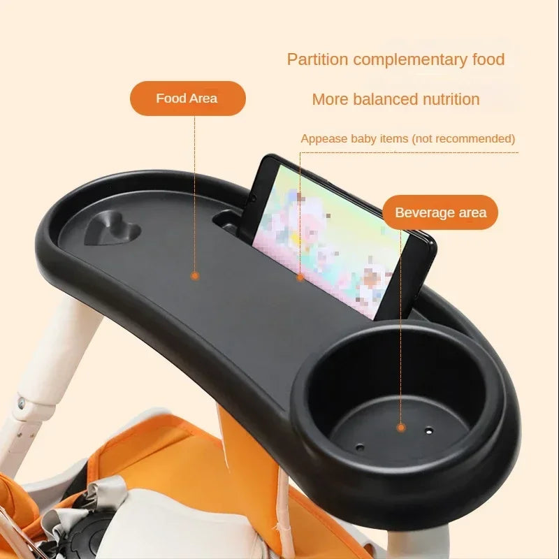 A black partition tray for a stroller holds food and a phone, designed to provide balanced nutrition.