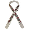 A beige woven guitar strap with red floral embroidery and leather accents, shown diagonally.