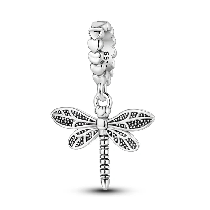 A sterling silver charm bead featuring an intricate dragonfly design.