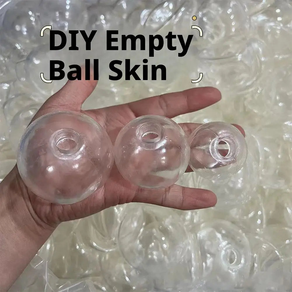 A hand holds three clear empty ball skins for DIY squishy stress balls on a white background.