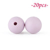 Two round, pink silicone beads are shown against a white background.